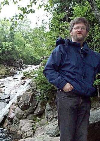 Photo of Jeffrey at a waterfall along the Cabot Trail