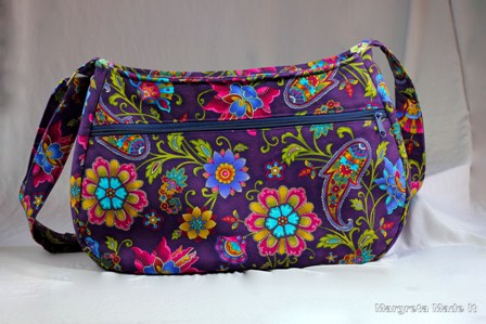 Jacobean fabric (purple, teal, magenta) covers this large purse. Inside fabric is a coordinating lime green. 